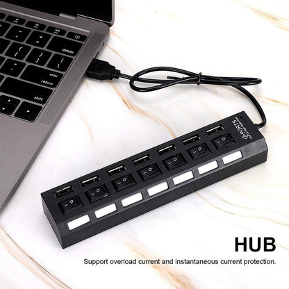 Wukusy 7-port USB 2.0 splitter hub with independent on/off switches, LED indicators, connected to a PC with various devices.