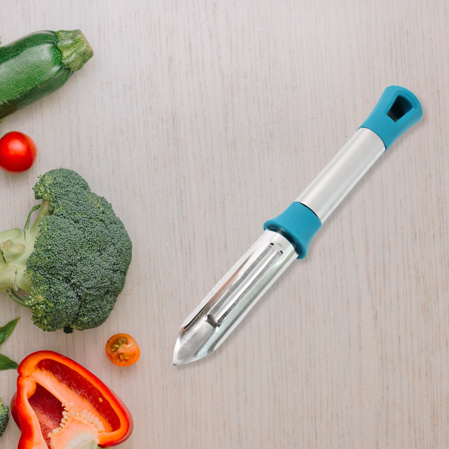 Wukusy Apex Premium stainless steel vegetable and fruit peeler with ergonomic handle on a kitchen countertop