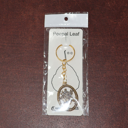 Golden Maa Durga oval keychain by Wukusy featuring intricate design, perfect for adding spiritual charm to keys or bags.