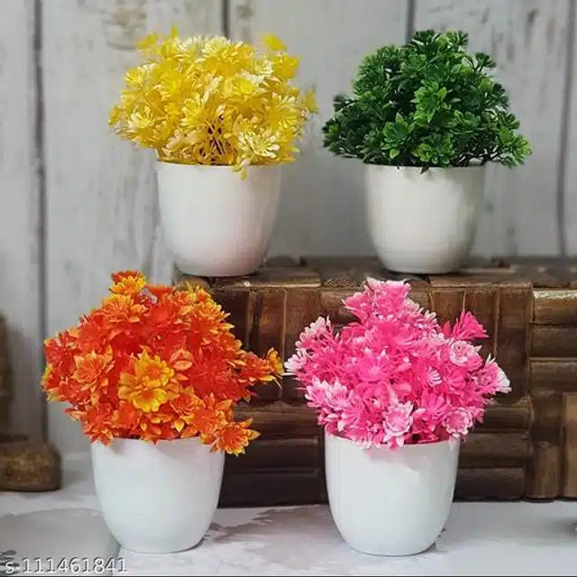Set of four multicolor artificial plants with pots, featuring realistic flowers and shrubs for home decor.