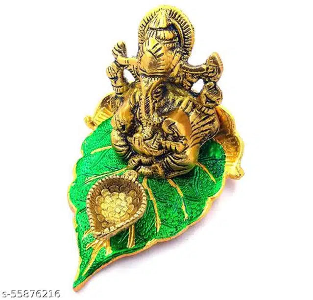 Brass God Ganeshji diya set with green accents, traditional diyas and lanterns for religious and decorative use.
