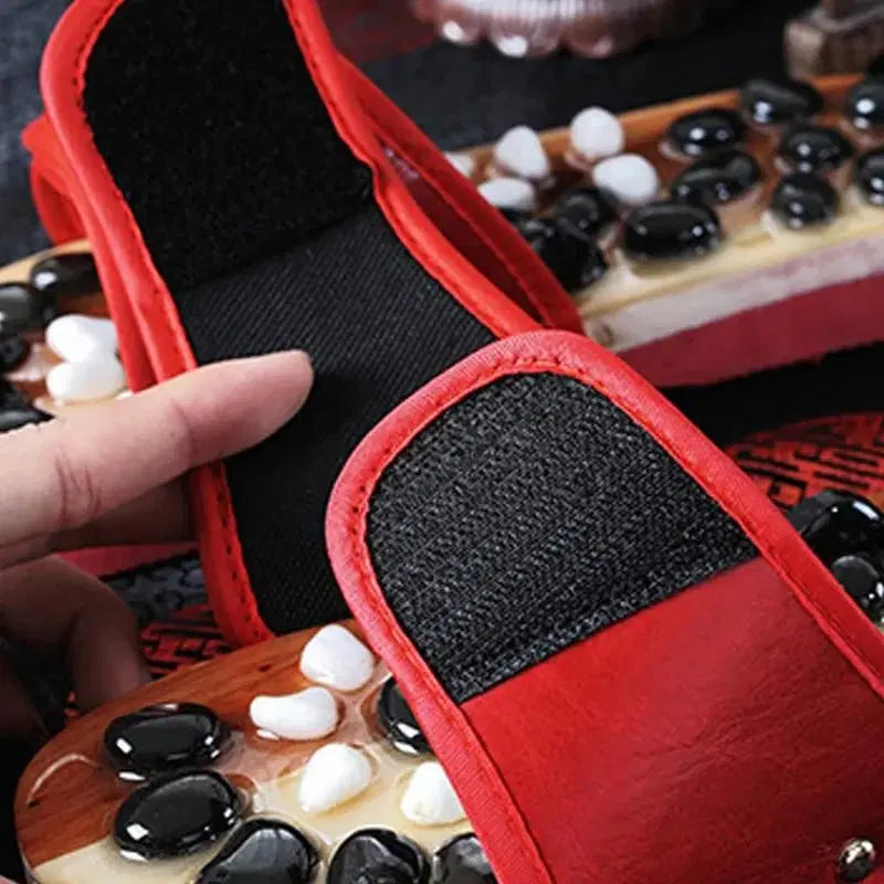 Red acupressure natural stone slippers by 1238 with textured soles designed for foot massage and comfort.
