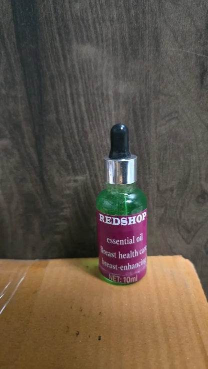 Two 20 ml bottles of 16182 Essential Oil Bust Enhancing oil, displayed with oil heater for health care and bust enhancement.