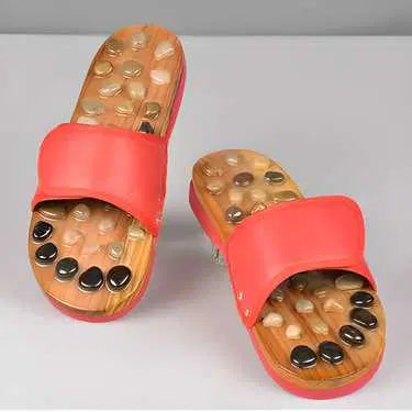 Red acupressure natural stone slippers from 1238, featuring textured soles designed for foot comfort and pressure point stimulation.