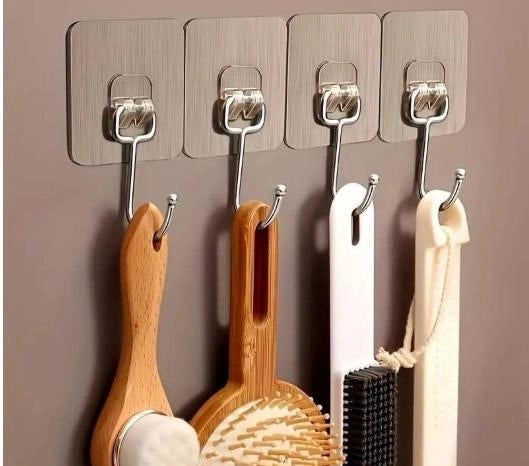 Pack of 10 large heavy-duty adhesive wall hooks by 35884, showing strong, clear hooks attached to a wall surface.