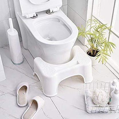 Plastic squat stool for Western toilets, designed to help with proper posture during toilet use, featuring a sturdy, compact design.