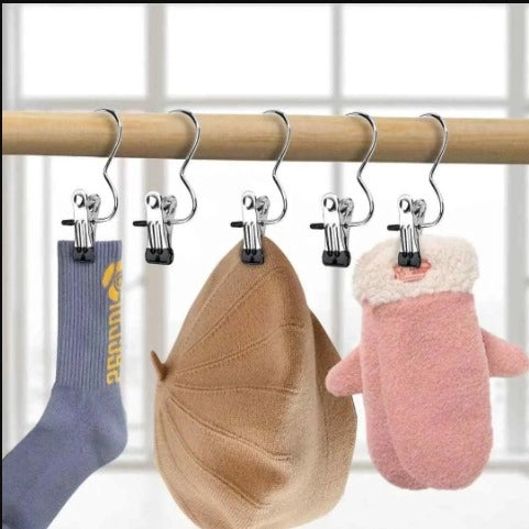 Set of 10 stainless steel cloth hangers with clips, stylish and durable laundry accessories by 35561, shown with clips attached.