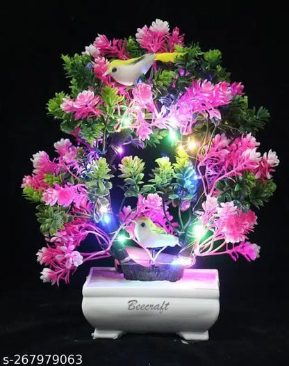 Artificial bonsai plant with pink and green foliage in a pot, featuring integrated light, ideal for home or office decor.