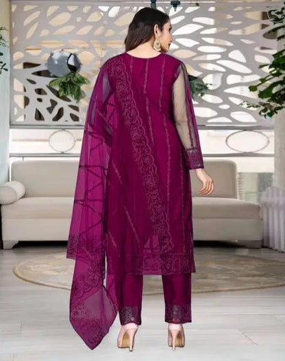 Elegant women's kurta set with matching dupatta and bottomwear, featuring intricate embroidery and vibrant fabric details.