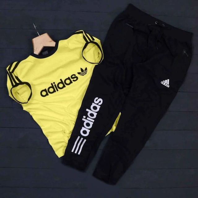 Yellow and black Adidas men's summer tracksuit with jacket and pants, stylish athletic wear for warm weather.