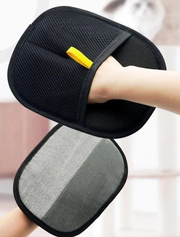 Pet hair removal glove from 25544, shown in use on a pet bed, with textured surface for removing pet hair and dander.