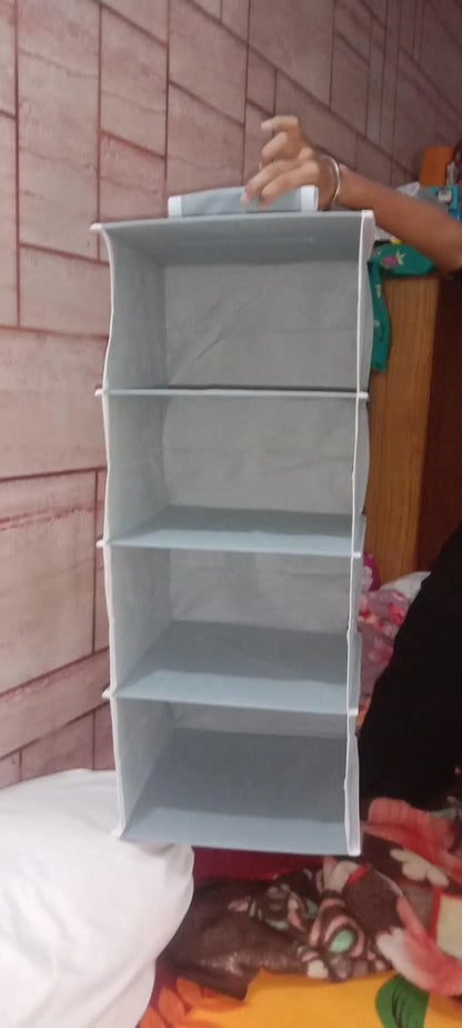 Hanging cloth wardrobe organizer with four shelves for clothes and accessories, by 1238, ideal for closet storage.