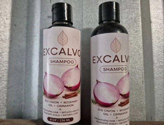 Pair of Excalvo Onion Shampoo bottles by 35912 with labels, showcasing clear bottles and shampoo inside.