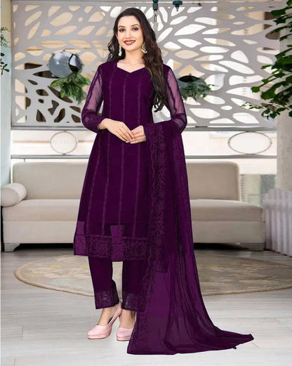Elegant women's kurta set with matching dupatta and bottomwear, featuring intricate embroidery and vibrant fabric from 15801.