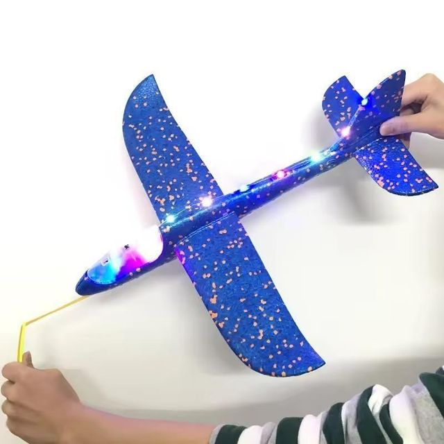 Large 33cm foam flash glider airplane from electronic toys brand 19357, shown flying with bright colors and aerodynamic design.