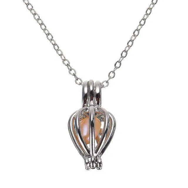 Freshwater shell and real pearl necklace set for kids with ocean-themed design, featuring a charm and delicate chain.