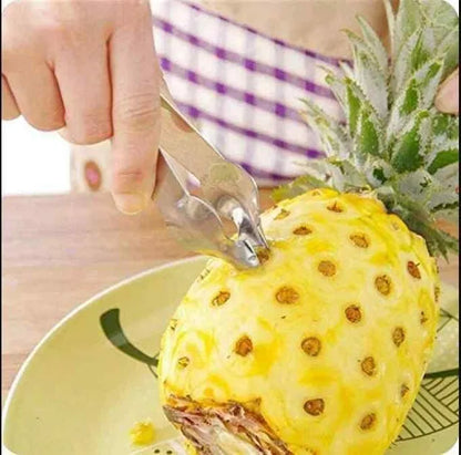 Stainless steel pineapple-shaped eye remover clip used as a decorative paper clip for organizing documents.