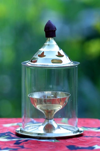 Brass and glass Akhand Deep Diya with cover for puja, traditional oil lamp for spiritual rituals and prayer ceremonies.