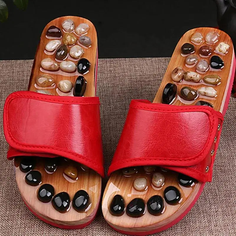 Red acupressure natural stone slippers by 1238, showing textured stone soles and comfortable slip-on design.