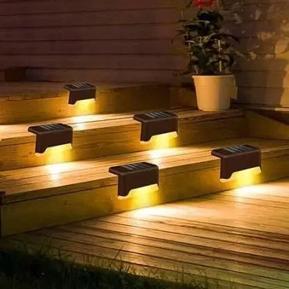 Outdoor solar deck lights by 1238 illuminating a wooden deck at night with warm, energy-efficient night lighting.