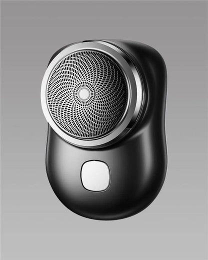 Close-up of the 1238 Mini Electric Shaver showing its compact design with a stainless steel shaving head and ergonomic grip.