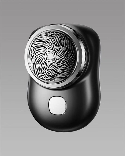 Close-up of the 1238 Mini Electric Shaver showing its compact design with a stainless steel shaving head and ergonomic grip.