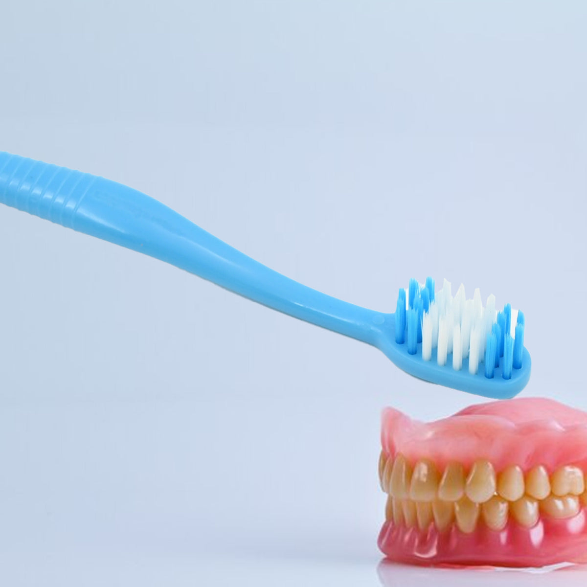 Wukusy 2-in-1 soft toothbrush and tongue cleaner with plastic cover, for men, women, kids, and adults, in a compact case.