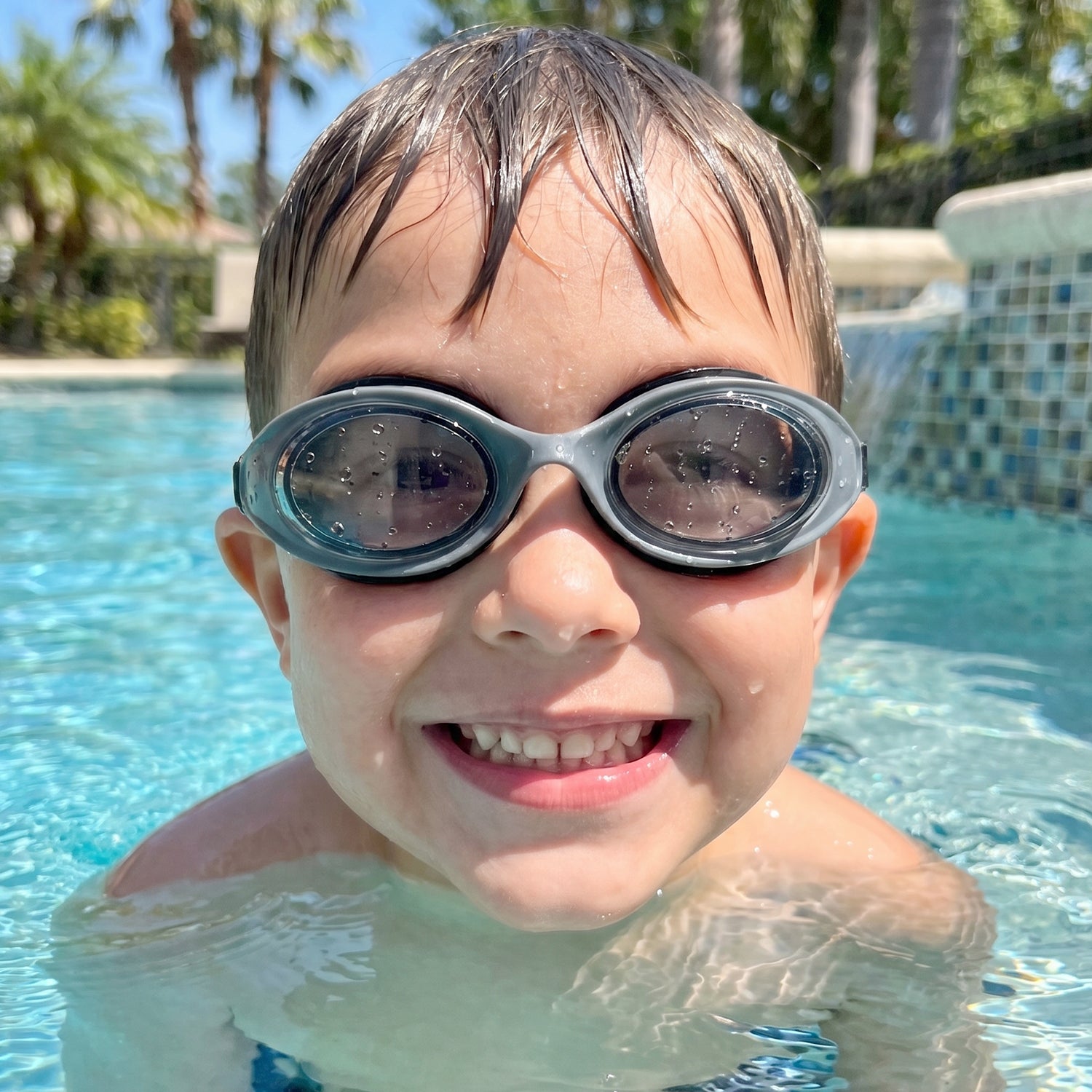 Kids UV protection swimming goggles with anti-fog lenses and a comfortable fit, featuring a secure strap and clear visibility.