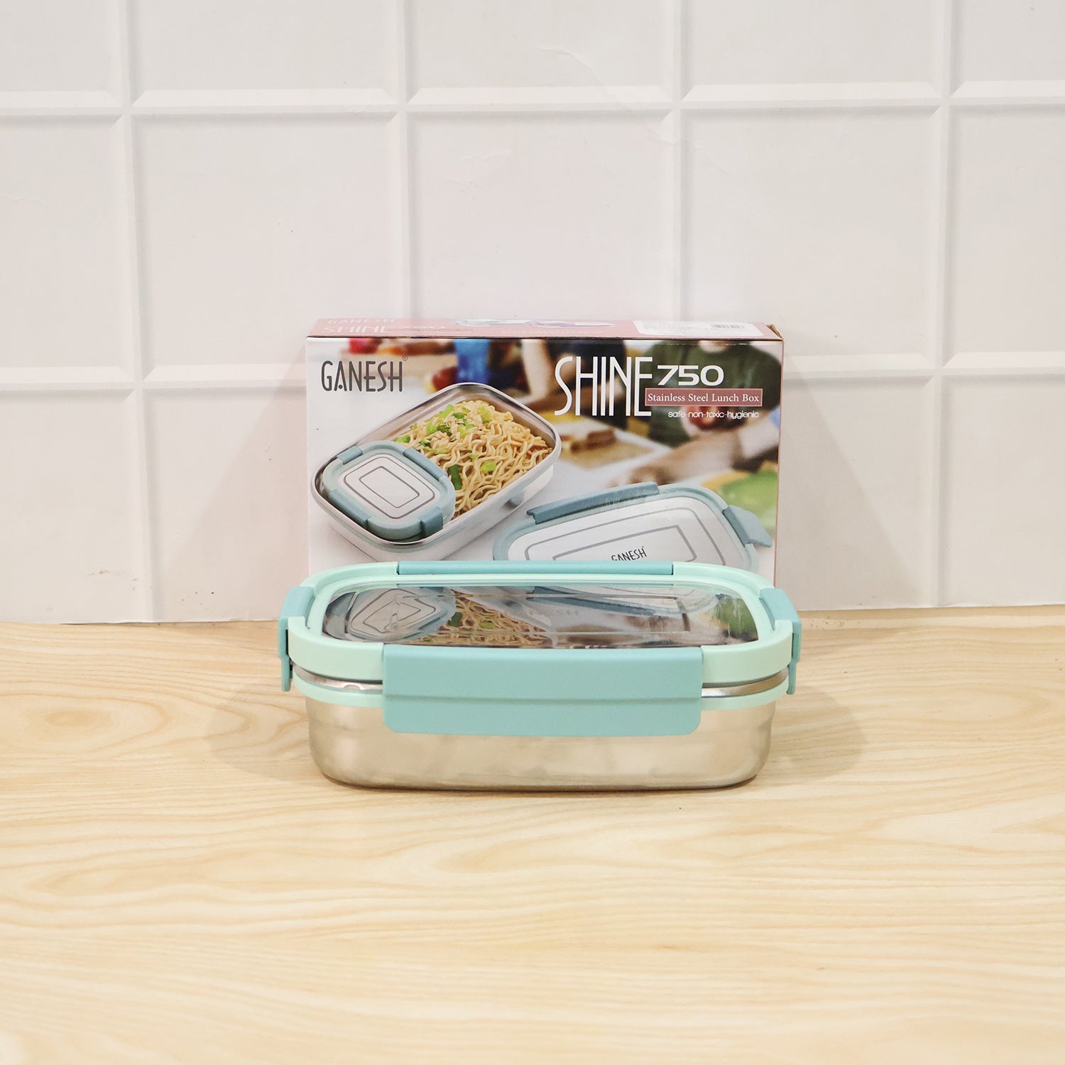 Wukusy Ganesh Shine 750 stainless steel lunch box set with small side container, featuring a polished finish and secure lid.