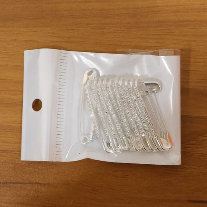 Set of 12 decorative silver finish safety pin brooches by Wukusy, featuring shiny metallic accents for stylish accessories.