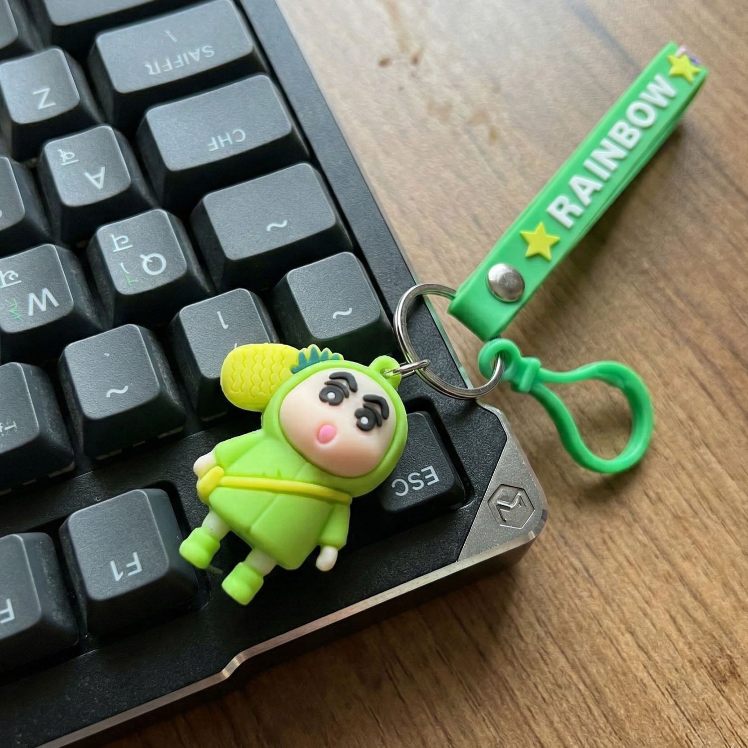 Cute cartoon doll keychain with pineapple charm and strap, featuring Wukusy brand design and vibrant, playful details