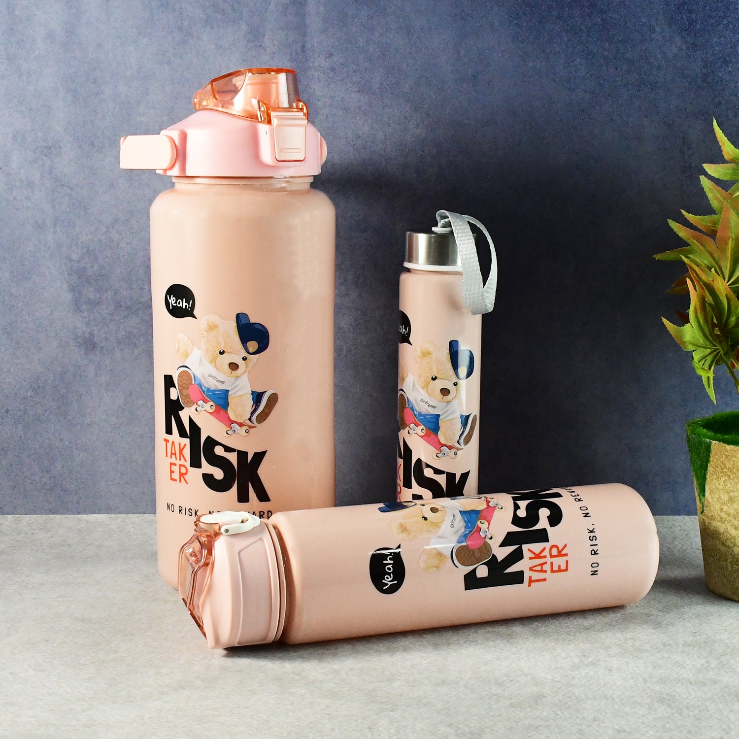 Set of three Wukusy cartoon printed water bottles for kids, featuring colorful, playful designs in a home and kitchen setting.