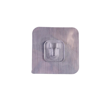 Heavy duty Wukusy self-adhesive utility wall hook attached to a wall, used for hanging tools and household items.