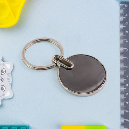 Black round metal keychain from Wukusy with sleek design, featuring a smooth surface and sturdy keyring.