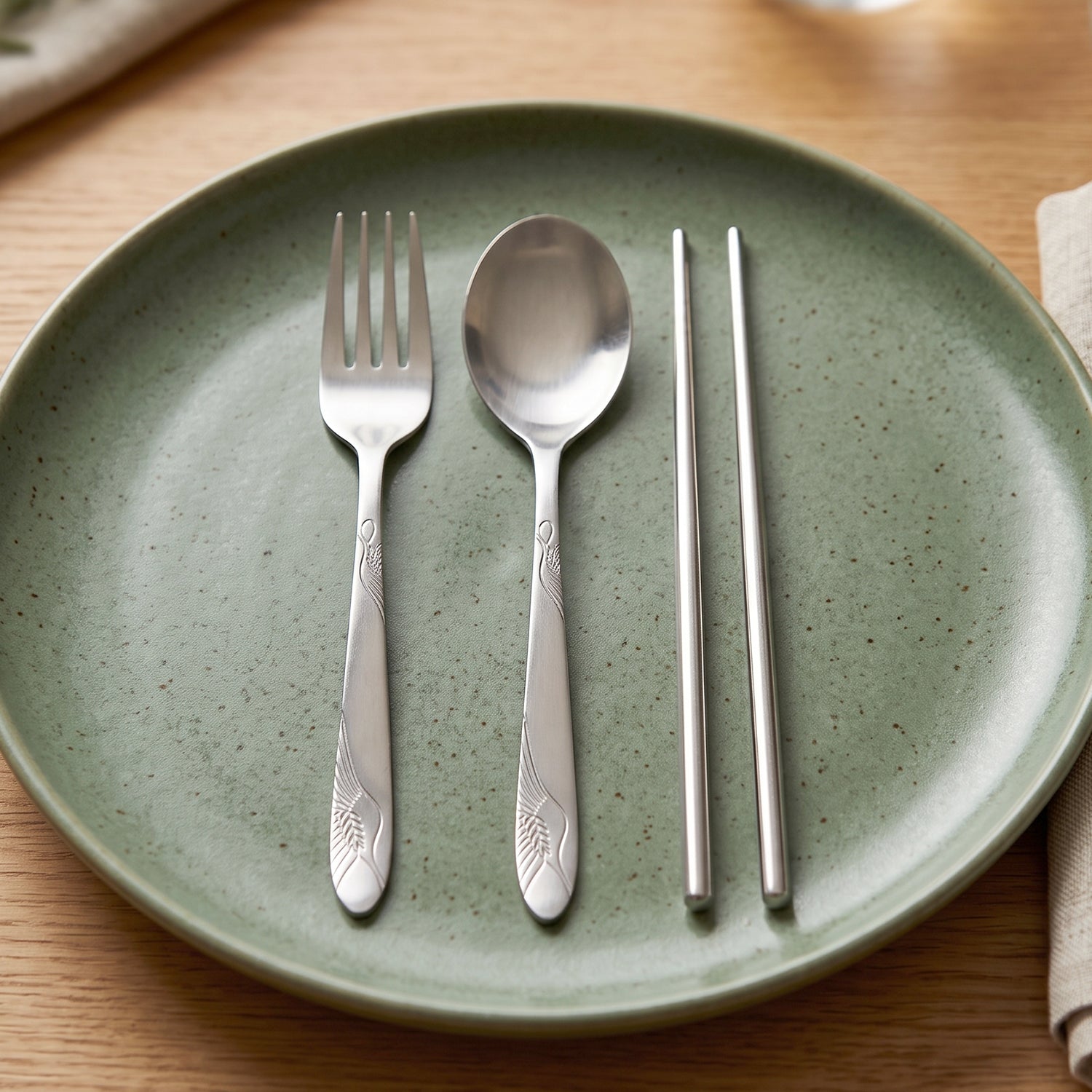 Wukusy portable stainless steel cutlery set with fork, spoon, chopsticks in a compact pouch, ideal for travel and outdoor dining.