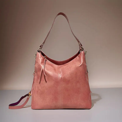 Black vegan leather shoulder bag for camping and hiking, spacious, water-resistant, lightweight with an adjustable strap.