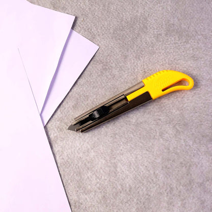 Wukusy heavy-duty stainless steel utility cutter knife with ergonomic handle and two extra blades, ideal for office and craft use.