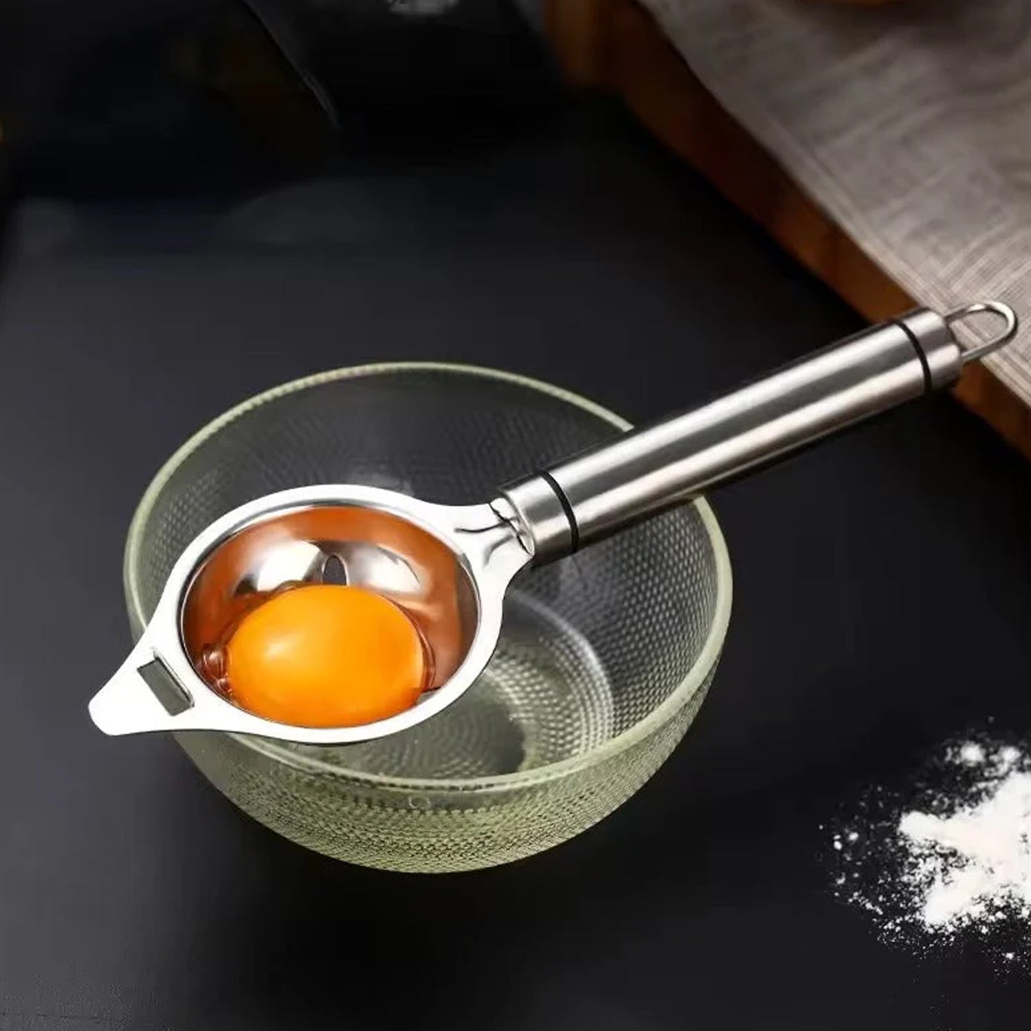 Wukusy premium stainless steel egg separator tool for kitchen use, showing the sleek, shiny utensil designed to separate eggs efficiently.
