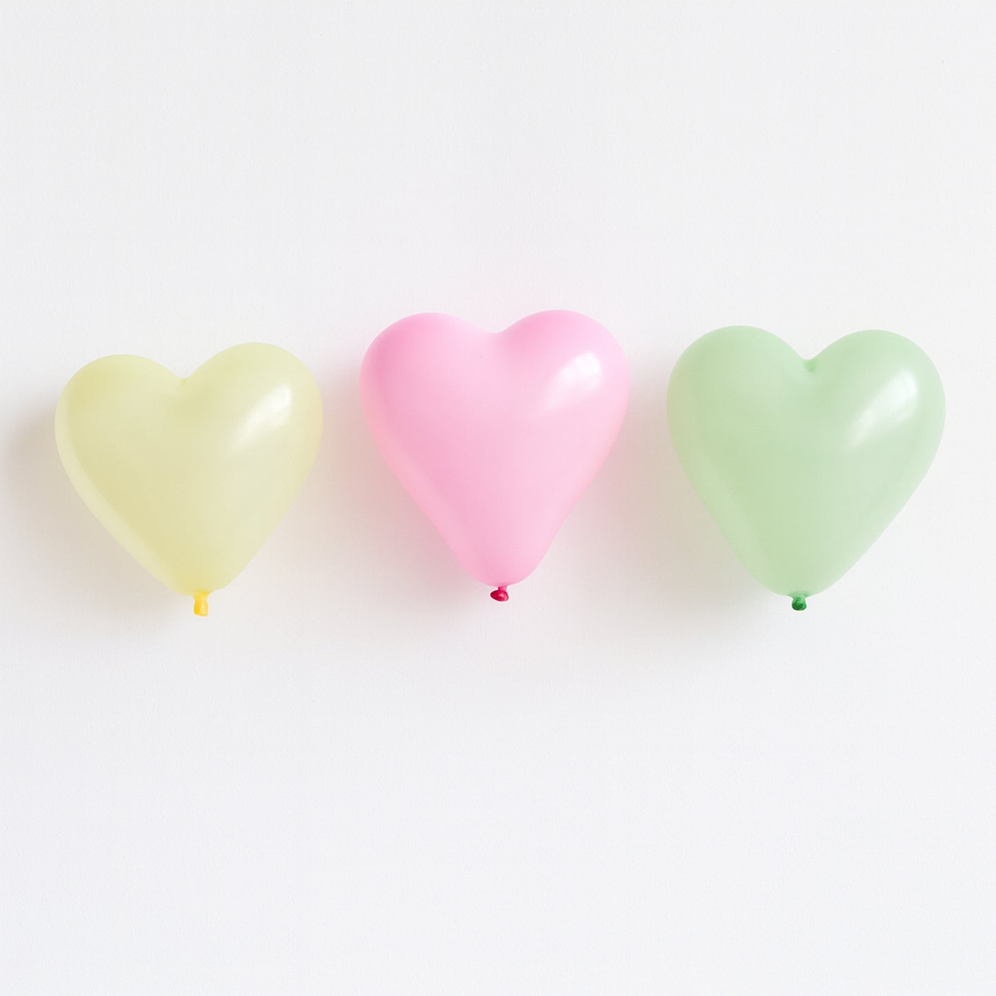 Heart-shaped balloon toy by Wukusy, premium quality, vibrant red color, floating in the air, perfect for celebrations and decorations.