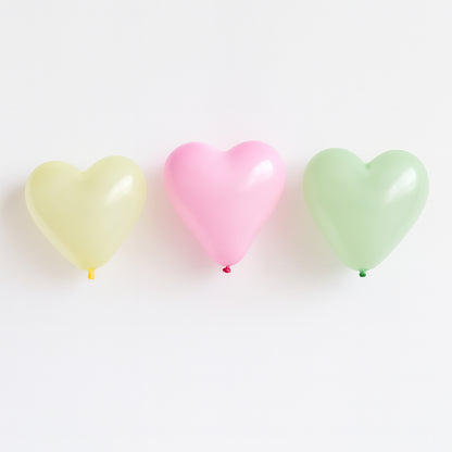 Heart-shaped balloon toy by Wukusy, premium quality, vibrant red color, floating in the air, perfect for celebrations and decorations.