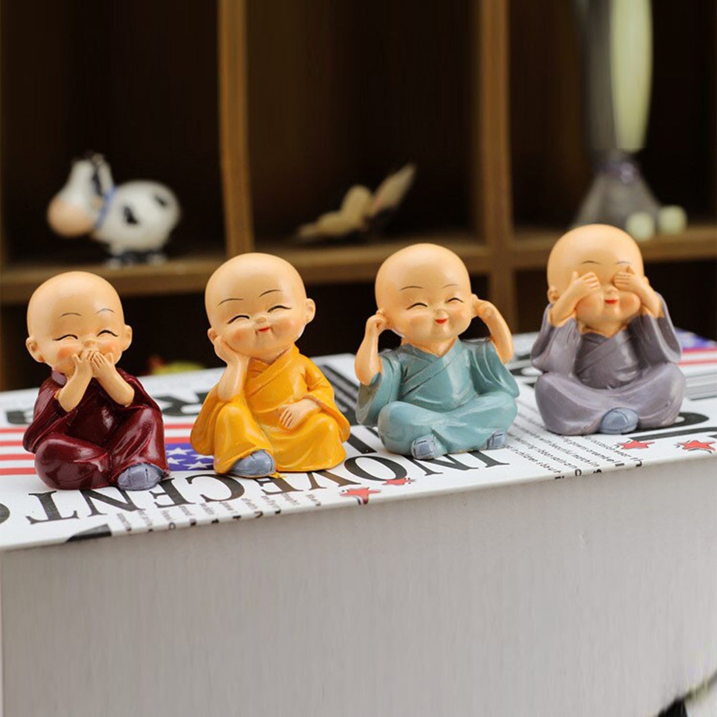 Wukusy Baby Buddha 4-piece toy set and showpiece for house, office, and official decorations, featuring small Buddha figurines.