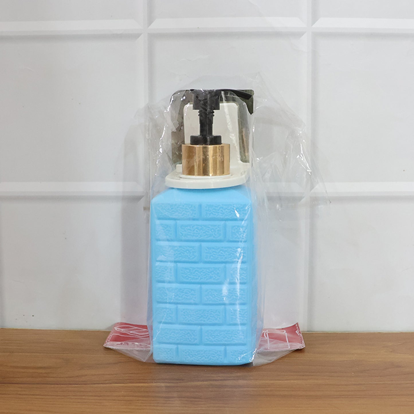 Wall-mounted Wukusy liquid soap dispenser set mounted on bathroom or kitchen wall with pump and transparent container.