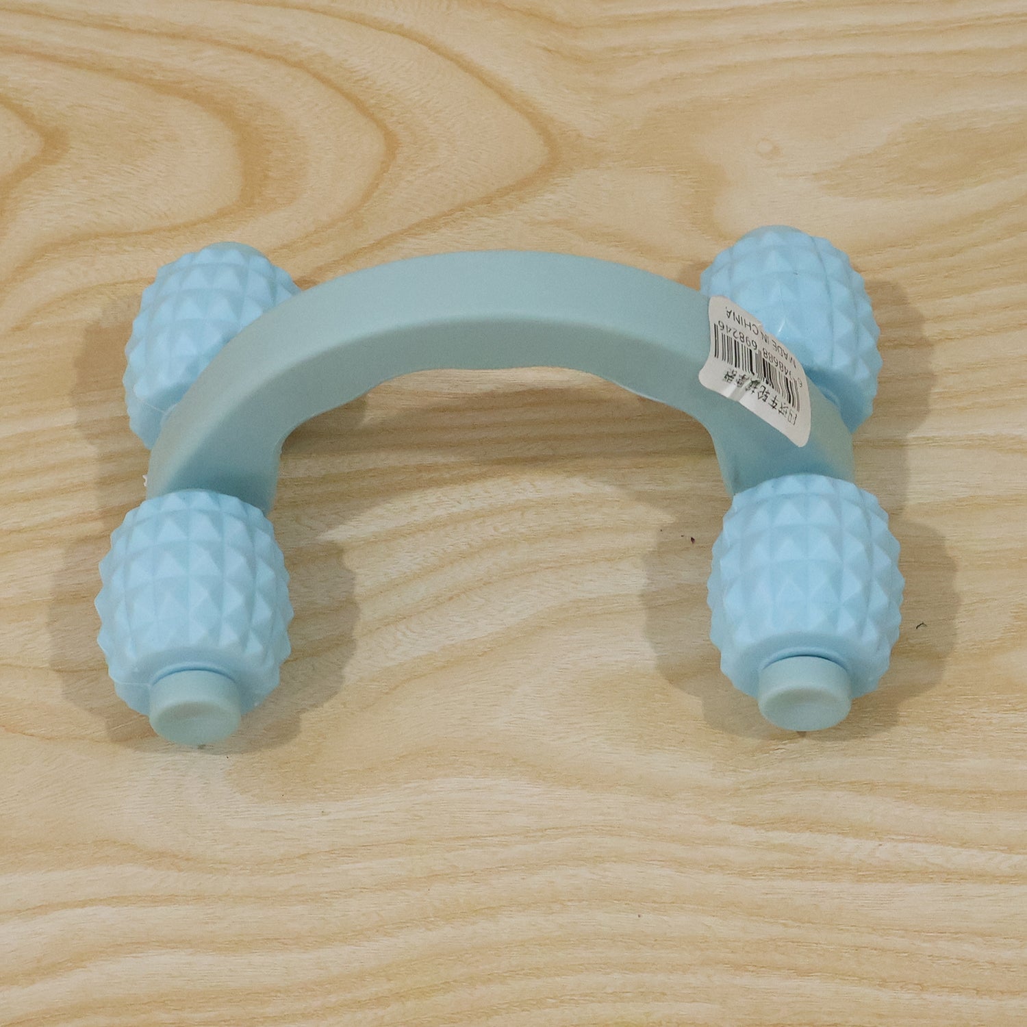 Wukusy handheld 4-roller body massager for muscle relaxation, shown being used on arms, legs, and back.