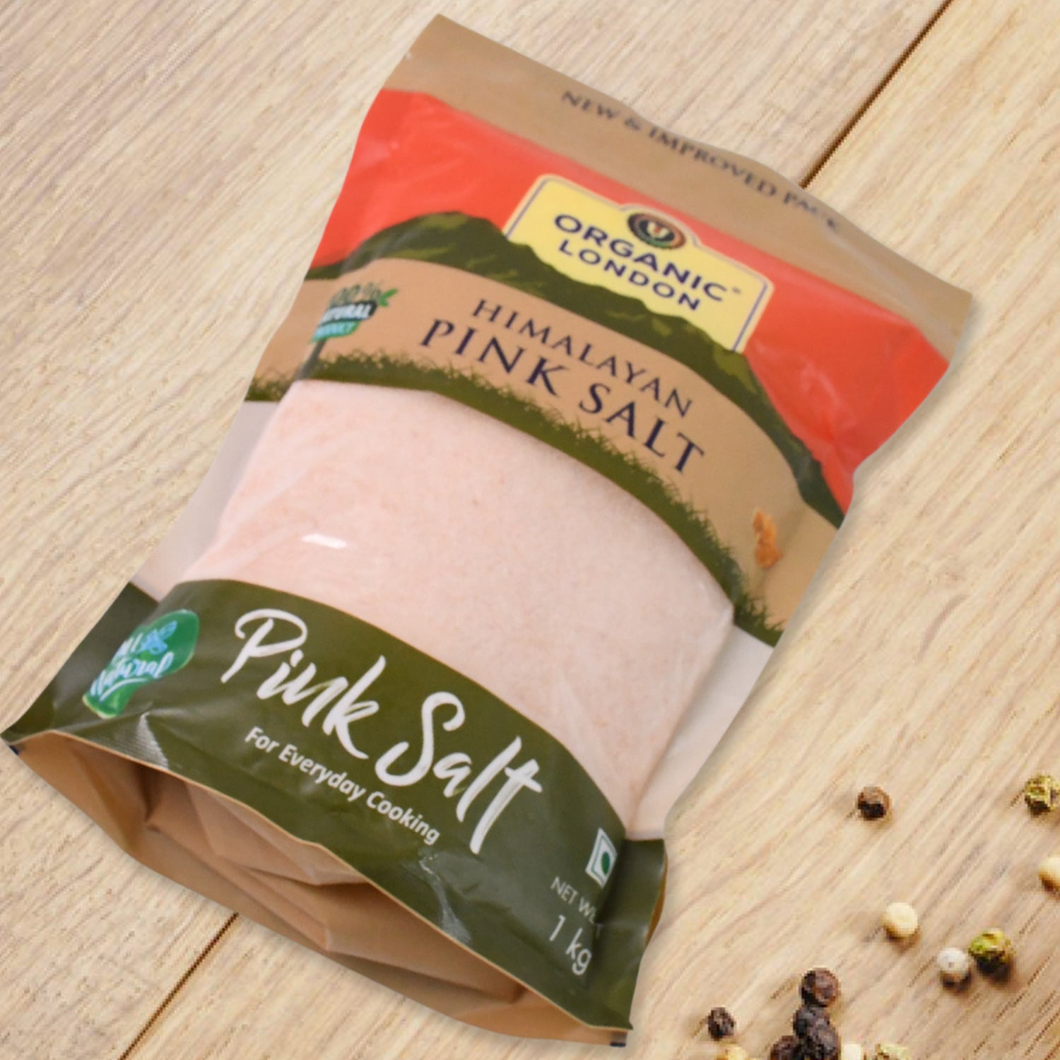 Organic Himalayan pink salt crystals in a 1 kg bag by Wukusy, showcasing pink mineral-rich salt with a natural, coarse texture.