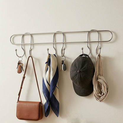 Wall-mounted metal multi hook rack by Wukusy with five hooks for organization and storage on a sturdy metal frame.