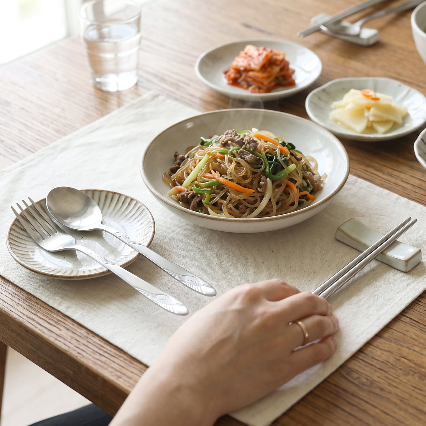 Wukusy portable stainless steel cutlery set with fork, spoon, chopsticks, and pouch, compact and travel-friendly for dining on the go.