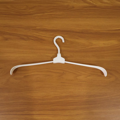 Wukusy premium foldable plastic clothes hanger hanging on a closet rod, showcasing its compact, lightweight design for clothing organization.