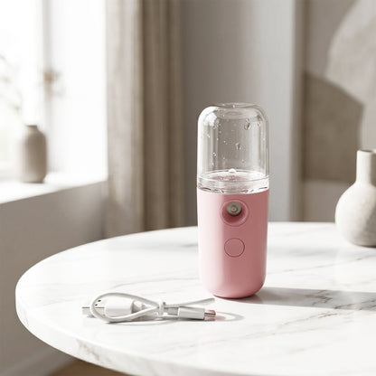 Wukusy mini nano mist sprayer and portable face steamer with USB rechargeable design, showing the compact device and mist output.