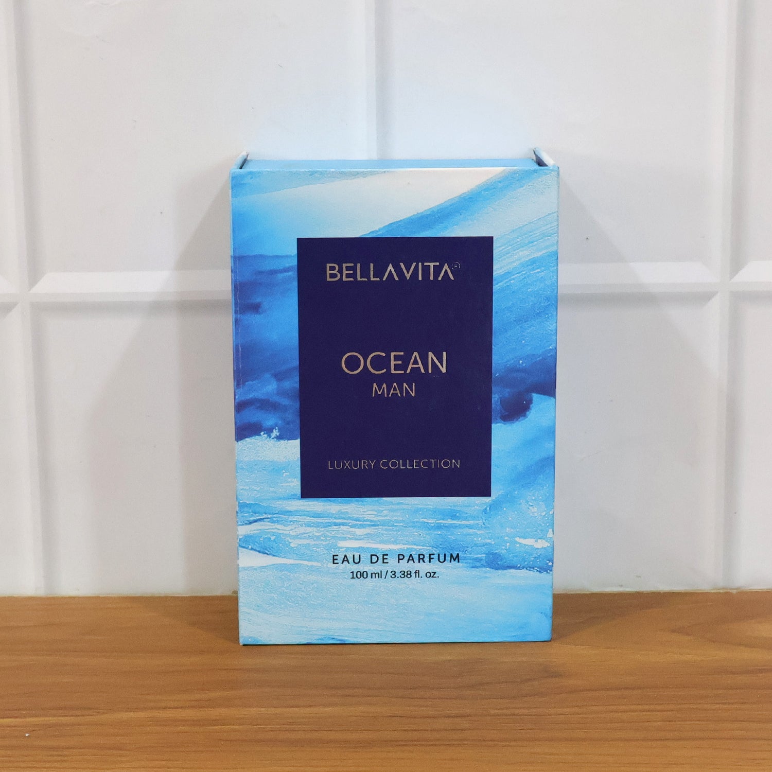 Bellavita Premium Ocean Man Eau De Perfume bottle by Wukusy, showcasing sleek design and clear glass with blue liquid inside.