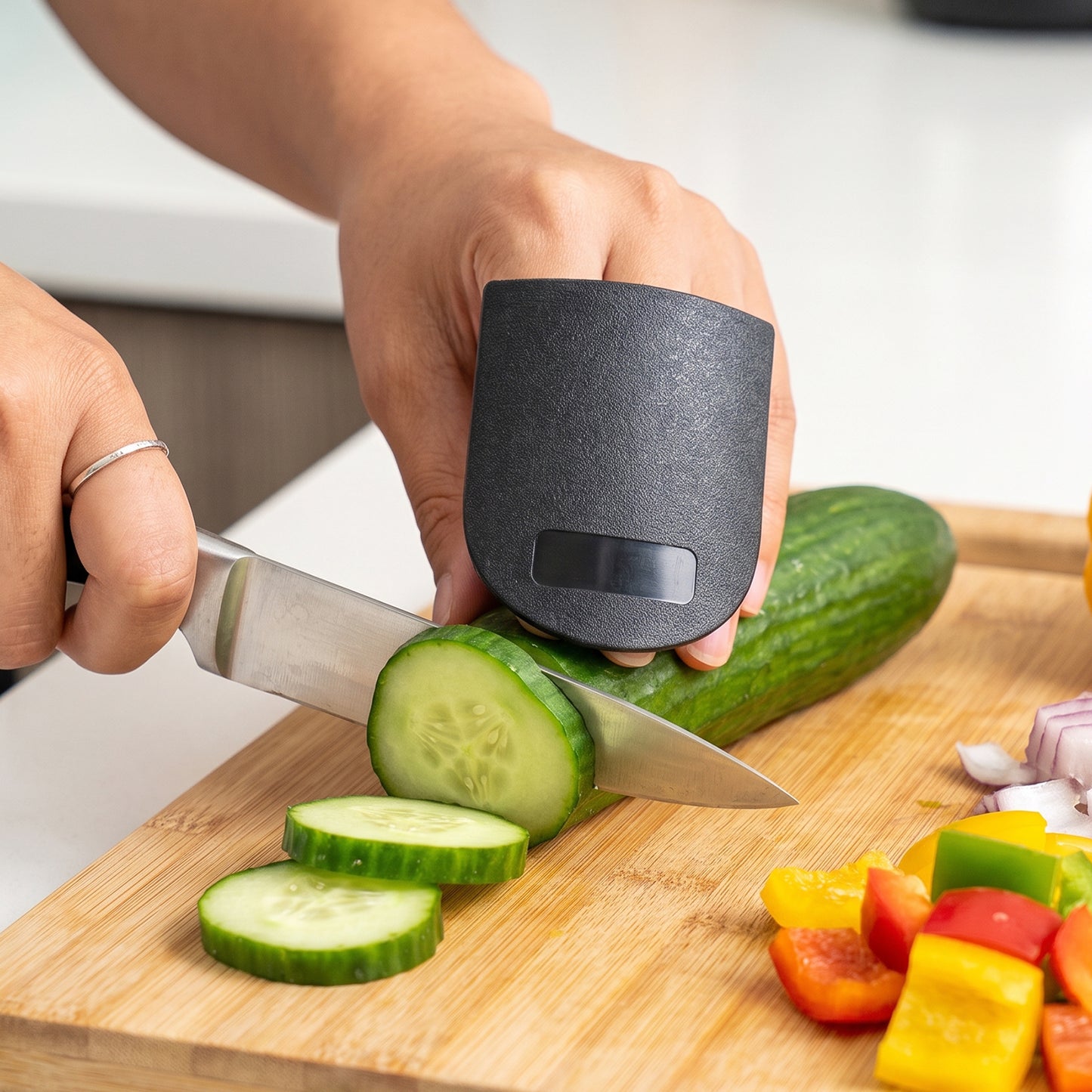 Wukusy finger guard protector for kitchen cutting and chopping safety, shown in mixed colors on a white background.